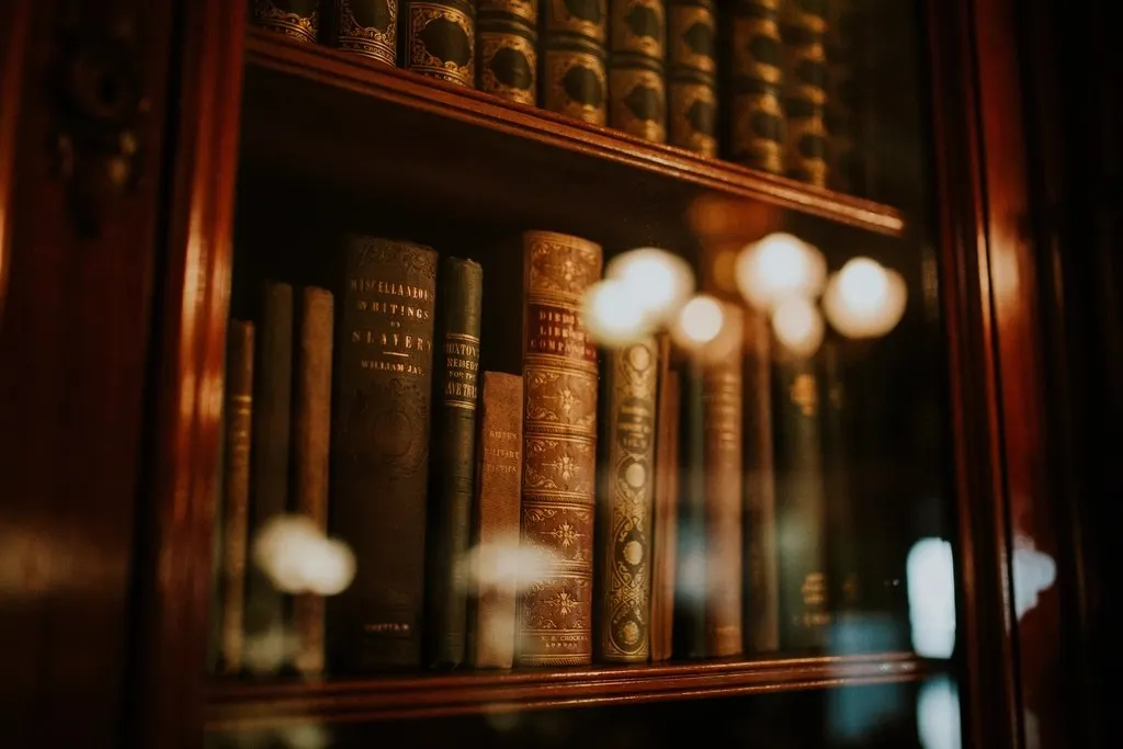 Leather-bound law books in a wooden bookcase.